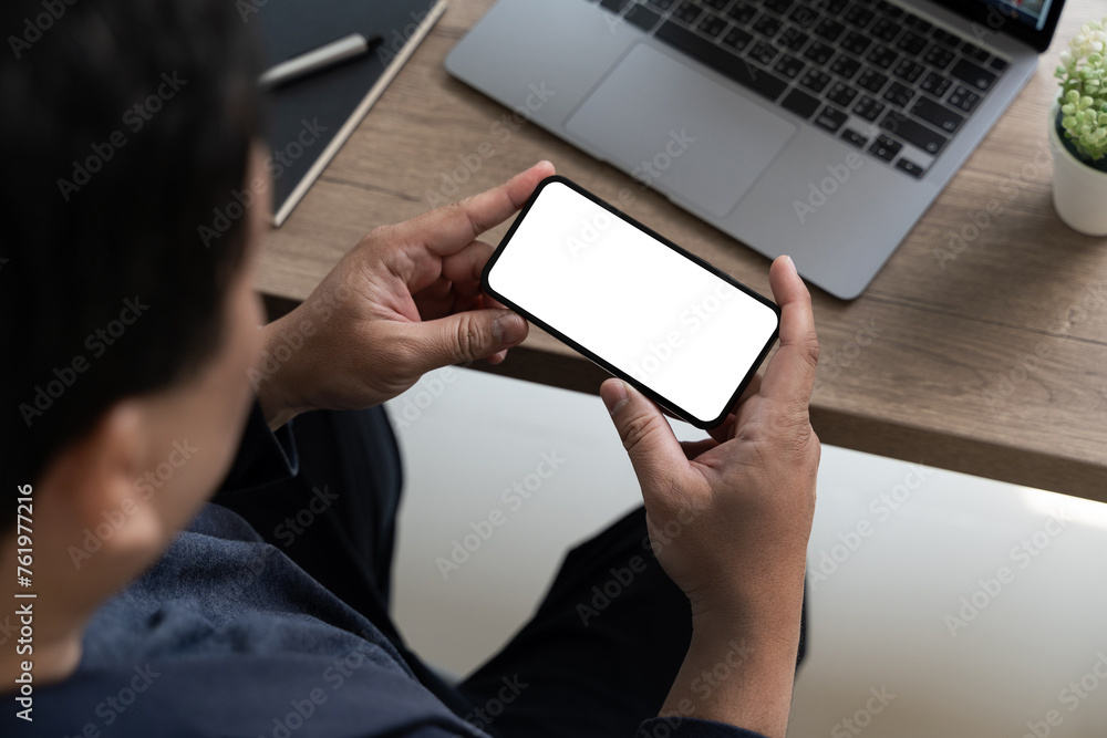 Poster top view mockup image hand using a smartphone man holding cell phone with blank screen
