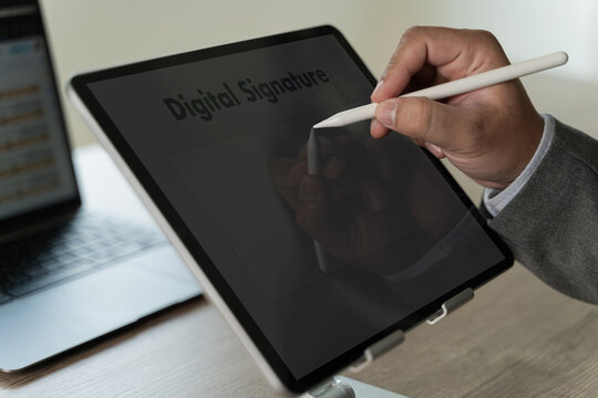 Close up businessman hand electronic Signature on Tablet Sign document of deal on digital gadget