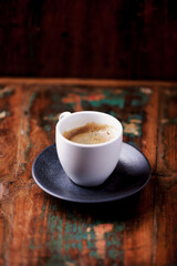 Cup of coffee on rustic wooden background. Copy space.	
