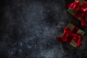 Two Golden Gift Boxes On Dark Background With Copy Space