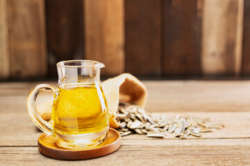Sunflower oil and sunflower seeds On a traditional rustic wooden floor Concept of organic food and...