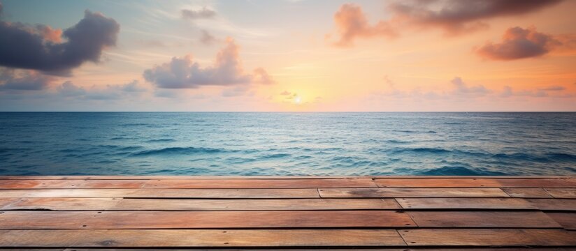 Wooden planks placed on sandy beach with sun setting in the horizon