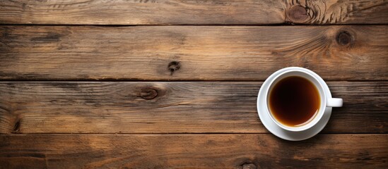 A cup of coffee on a wooden table with a wooden background