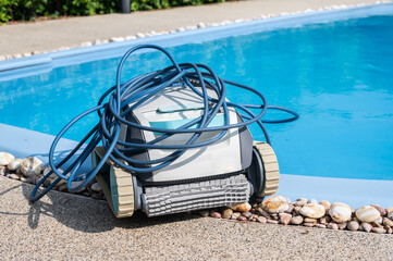 A Robotic pool cleaner preparation at the poolside before using it.