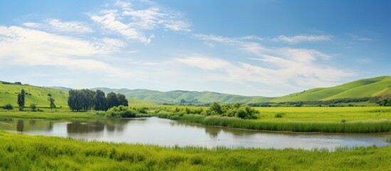 Fototapeta premium Lake surrounded by lush hills and forest
