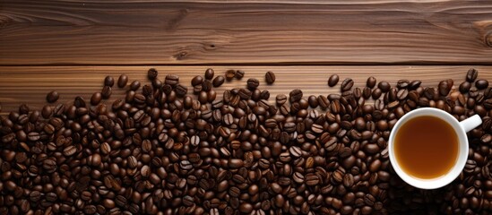 A cup of coffee with coffee beans on a wooden table