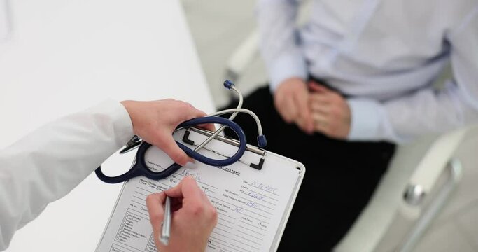 Competent doctor makes important notes during consultation