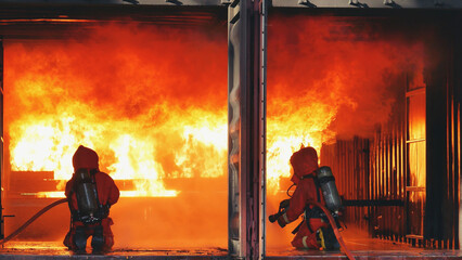Firefighter fighting with fire flame protection property. Fireman wear hard hat, body safe suit...