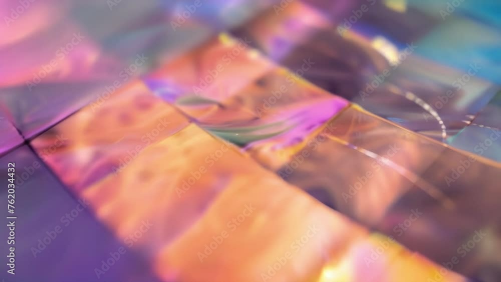 Poster a closeup shot of a holographic film being stretched and manipulated revealing the intricate lines a