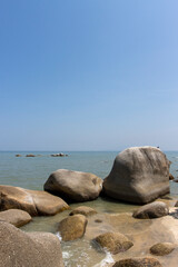 Fototapeta na wymiar Tropical beach with boulders in Batu Ferringgi, Penang, Malaysia, Asia