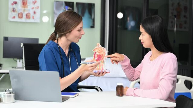 Portrait of female doctor explaining diagnosis to her patient. Doctor Meeting With Patient In Exam Room. A medical practitioner reassuring a patient in hospital.