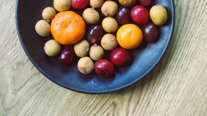 Various fruits served on black plate