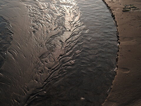 A water drain-off track in the sand