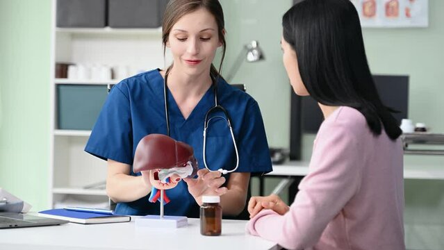 Portrait of female doctor explaining diagnosis to her patient. Doctor Meeting With Patient In Exam Room. A medical practitioner reassuring a patient in hospital
