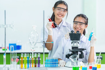Two presenters from the Ministry of Public Health are scientists holding test tubes, microscopes,...