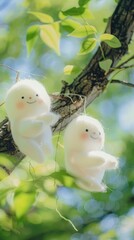 Two cute white smiling ghost dolls cotton hanging on a tree, green leaves background.