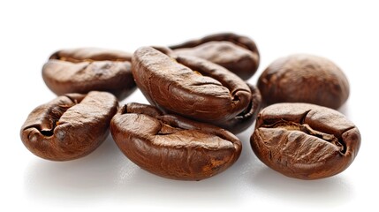 Close up of roasted coffee beans with rich texture against a white background