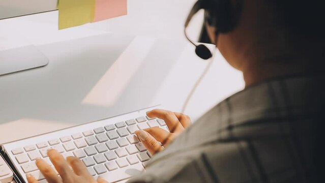 close up headphone asian girl press number on telephone and response answer customer or partner in operation room for business and technology concept.