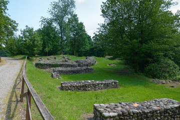 Ruins of a fortified settlement. Castelseprio, Italy and the bases of the access bridge to the fortifications  at the beginning of the route.  Archaeology park of Castelseprio, UNESCO Site