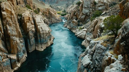 A tranquil river flowing through a canyon, carving its way through rugged cliffs