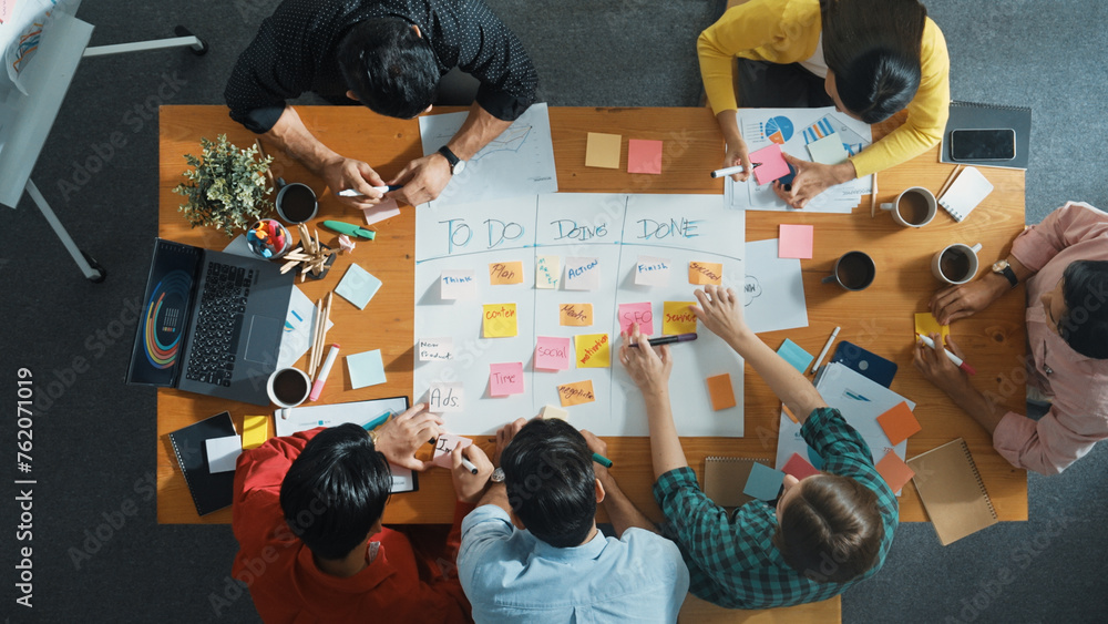 Poster top down aerial view of business team making scrum task board at meeting room. group of people writi