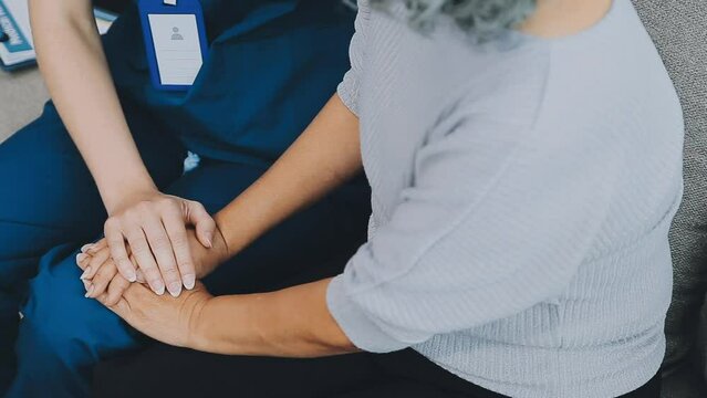 Emotional comfort stored in fingerprints. Shot of an unrecognizable doctor holding hands with her patient during a consultation..