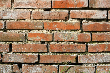 Fond d'un mur de vieilles briques oranges maçonnées