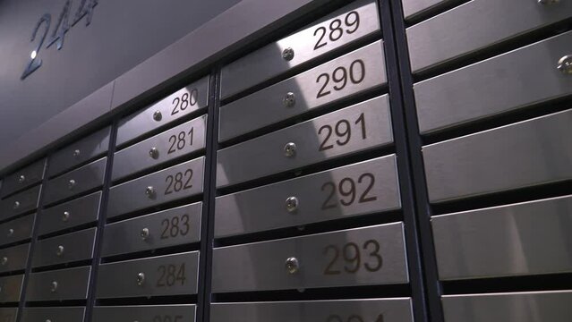 Metal mailboxes with apartment numbers in a multi-story building