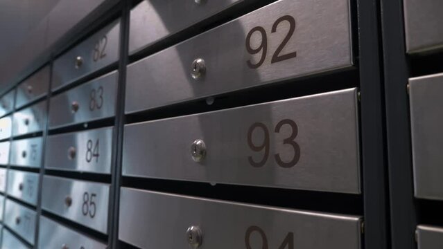 Metal mailboxes with apartment numbers in a multi-story building
