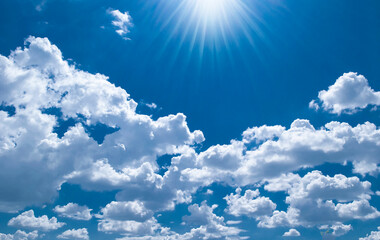 Sky with fluffy white cloudscape texture. Blue sky and sun nature background, horizontal