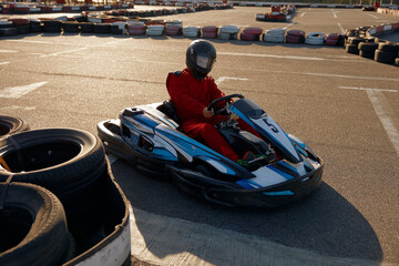 Diver racing on go-cart track outdoors enjoying competitive activity