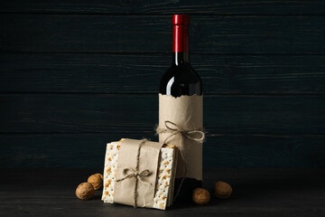 Matzo, nuts and bottle of wine on wooden background