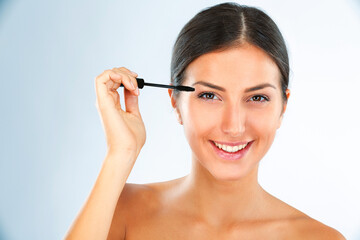Brush, mascara and woman in portrait with makeup for beauty, transformation and lashes on white...