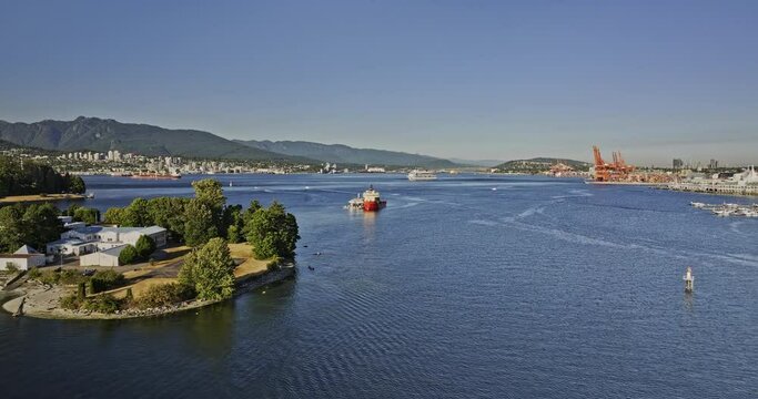 Vancouver BC Canada Aerial v34 low drone flyover the harbour capturing ships on the calm water, shipyards at Downtown Eastside and North shore mountain views - Shot with Mavic 3 Pro Cine - July 2023