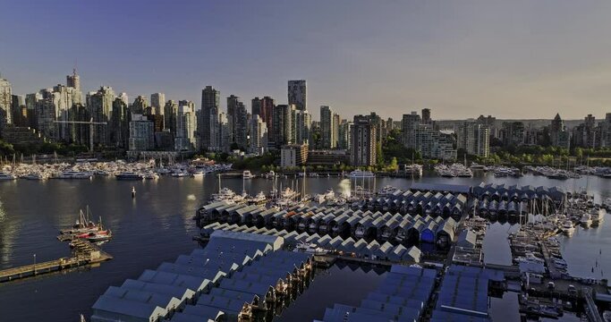 Vancouver BC Canada Aerial v57 low flyover marina towards Coal Harbour capturing boat shelters in yacht club facility against downtown and West End cityscape - Shot with Mavic 3 Pro Cine - July 2023