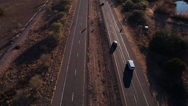 Aerial View of Traffic on Arizona State Route at Sunset, Landscape, Cars and Cracked Asphalt, Revealing Drone Shot