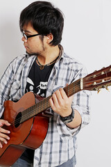 a guitarist playing acoustic guitar with a white background
