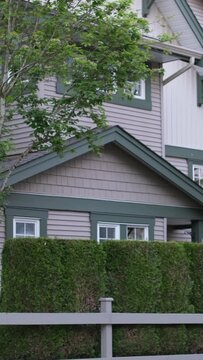 Custom built big luxury house with triple garage doors in a residential neighborhood. Suburbs of Vancouver Surrey Canada.