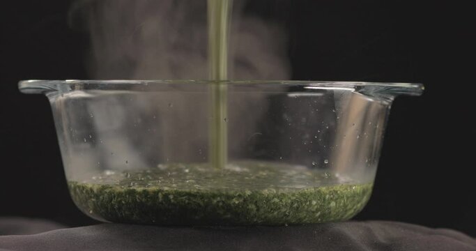 Egyptian Molokhya poured in a Bowl Glass and smoke is coming out freshly made and shot on 4K. Molokhya is a Famous Egyptian Food  in the Egyptian Cuisine and well known to be the most delicious one