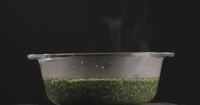 Egyptian Molokhya in a Bowl Glass and smoke is coming out freshly made and shot on 4K. Molokhya is a Famous Egyptian Food  in the Egyptian Cuisine and well known to be the most delicious one