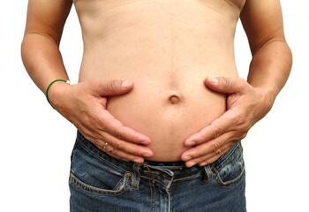 Close-up view of Man is belly. Wearing a blue jeans. There is a lot of excess fat. Fat groove until...