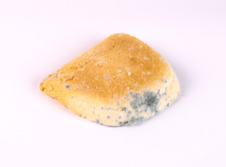 Moldy bread on a white background. Close-up.