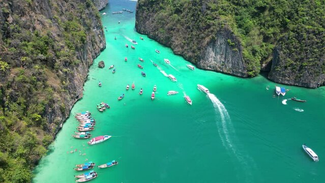 Aerial overview of tour boats entering Pileh Lagoon Pi ley in Koh Phi Phi island Thailand, aerial high angle