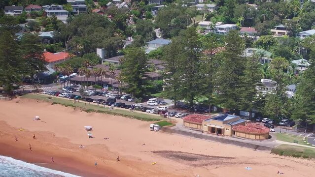 Aerial over the sand at Palm Beach and showing the beach buildings and life saving gear