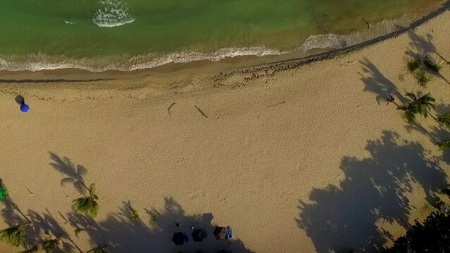 Descending overhead drone shot of the beachfront of Miami showing the surging waves of the Ionian Sea hitting the coast of Itea, in Central Greece.