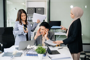 Fototapeta premium Furious Asian businesspeople arguing strongly after making a mistake at work in office