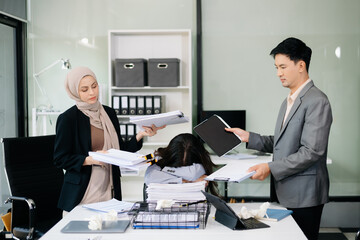 Furious Asian businesspeople arguing strongly after making a mistake at work in office