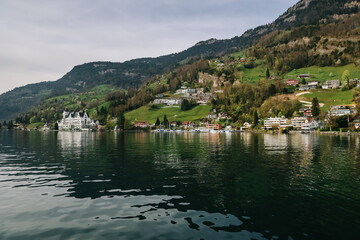 Fototapeta na wymiar Waterview on Swiss village, house or castle near Lucerne, Switzerland.