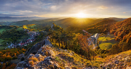 Mountains at sunset in Slovakia - Vrsatec. Landscape with mountain hills orange trees and grass in fall, colorful sky with golden sunbeams. Panorama - 762133658