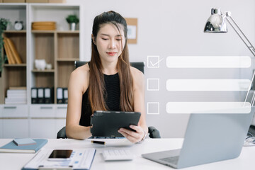 Obraz na płótnie Canvas Business performance checklist concept, Woman using tablet and laptop doing online checklist survey, filling out digital form checklist.